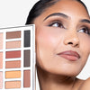 Woman showcasing a neutral-toned eyeshadow palette, highlighting expertly applied makeup with soft, natural colors.