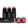 Assorted cream blush sticks on black tubes,  revealing the rounded blush tips and vibrant pink-purple hues. Blank background