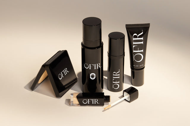 A collection of sleek, black beauty products labeled 