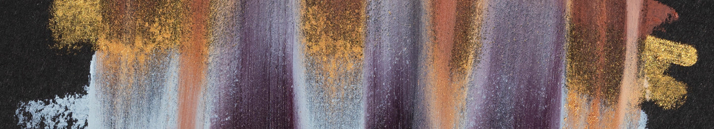 Abstract swatches of makeup colors, featuring shimmering gold, deep purple, and soft brown tones on a dark background.