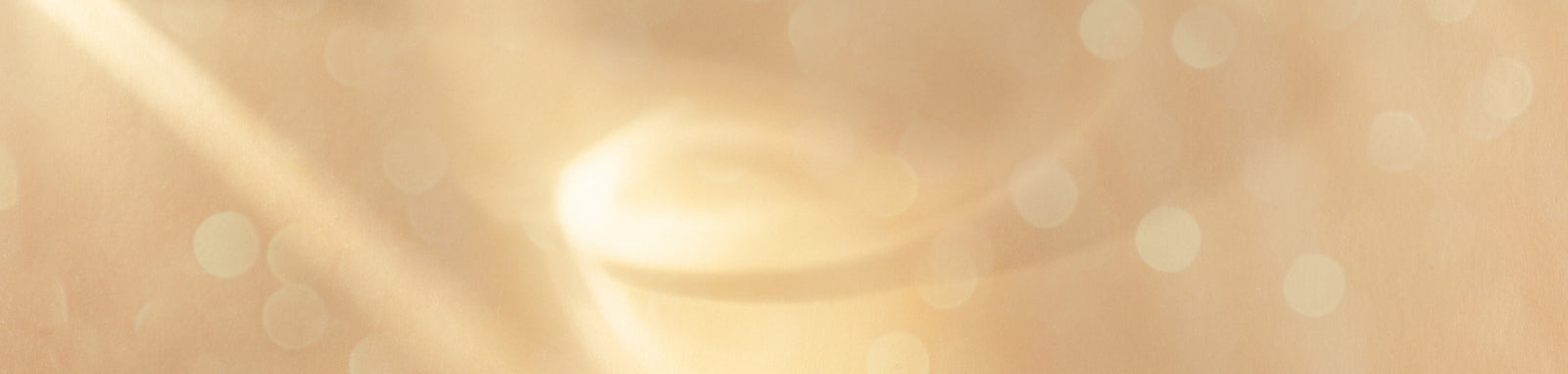 A soft, blurred background with warm golden tones and subtle bokeh light effects.