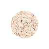 A circular, pale beige pressed powder with a cracked and textured surface, suitable for cosmetic use.