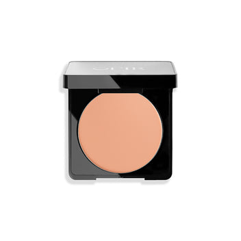 Open compact case with peach-toned pressed powder and a sleek black design.