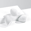 Three white makeup sponges with a soft, rounded design are displayed on a sleek white surface.
