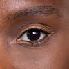Close-up of a well-defined eye with shimmering bronze eyeshadow and neatly applied black eyeliner.