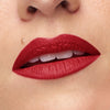 Close-up of lips wearing vibrant red lipstick with a smooth, matte finish.
