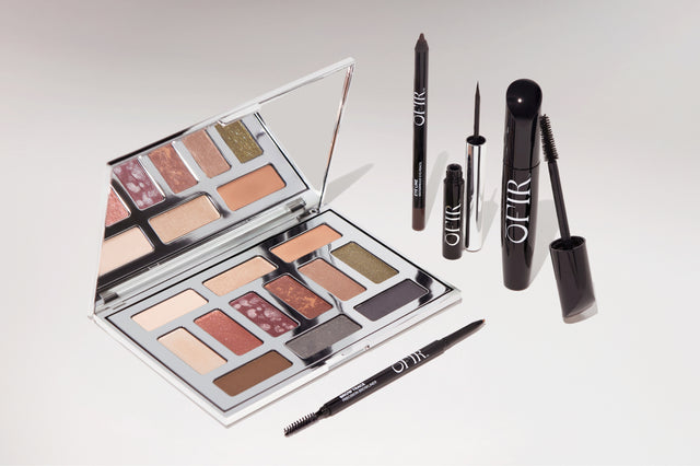 Makeup kit featuring a versatile eyeshadow palette with earthy tones, alongside black eyeliner, mascara, and brow pencil.