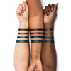 Three forearms showing swatches of four eyeliner colors labeled Onyx, Carob, Sapphire, and Marine.