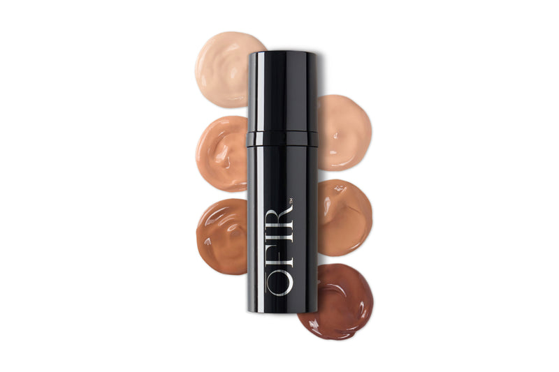 A sleek black bottle labeled "OFIR" is surrounded by swatches of foundation in a gradient of six shades from light to dark.