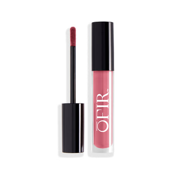 A tube of pink liquid lipstick with a matching applicator wand, featuring a sleek black cap and opaque container displaying the brand name.