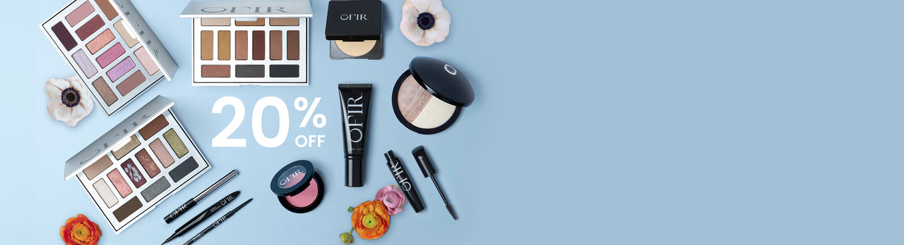 Cosmetic collection featuring eye shadow palettes, blush, foundation, highlighter, mascara, and eyeliner arranged against a soft blue background with a floral accent, highlighting a 20% discount offer.
