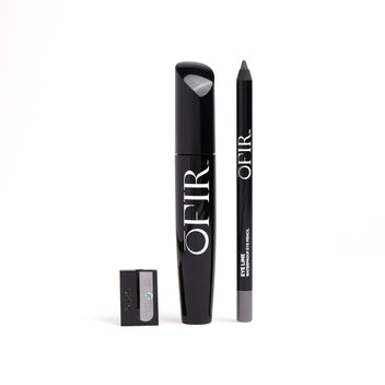 Black mascara, eyeliner pencil, and a sharpener set neatly arranged against a white background.