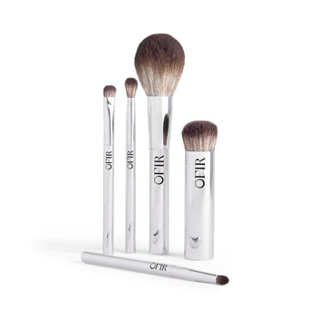 A set of five silver makeup brushes with soft bristles, each labeled with "OFIR," including various sizes for different cosmetic applications.