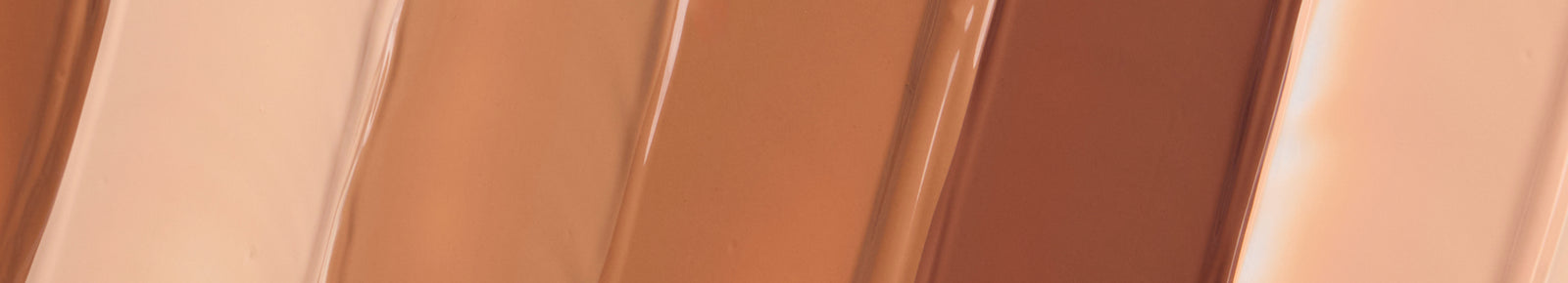 Swatches of liquid foundation showcasing a gradient of warm, neutral, and deep tones.